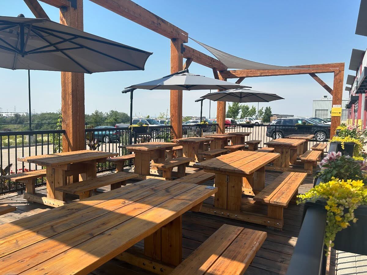 The patio with picnic tables and umbrellas