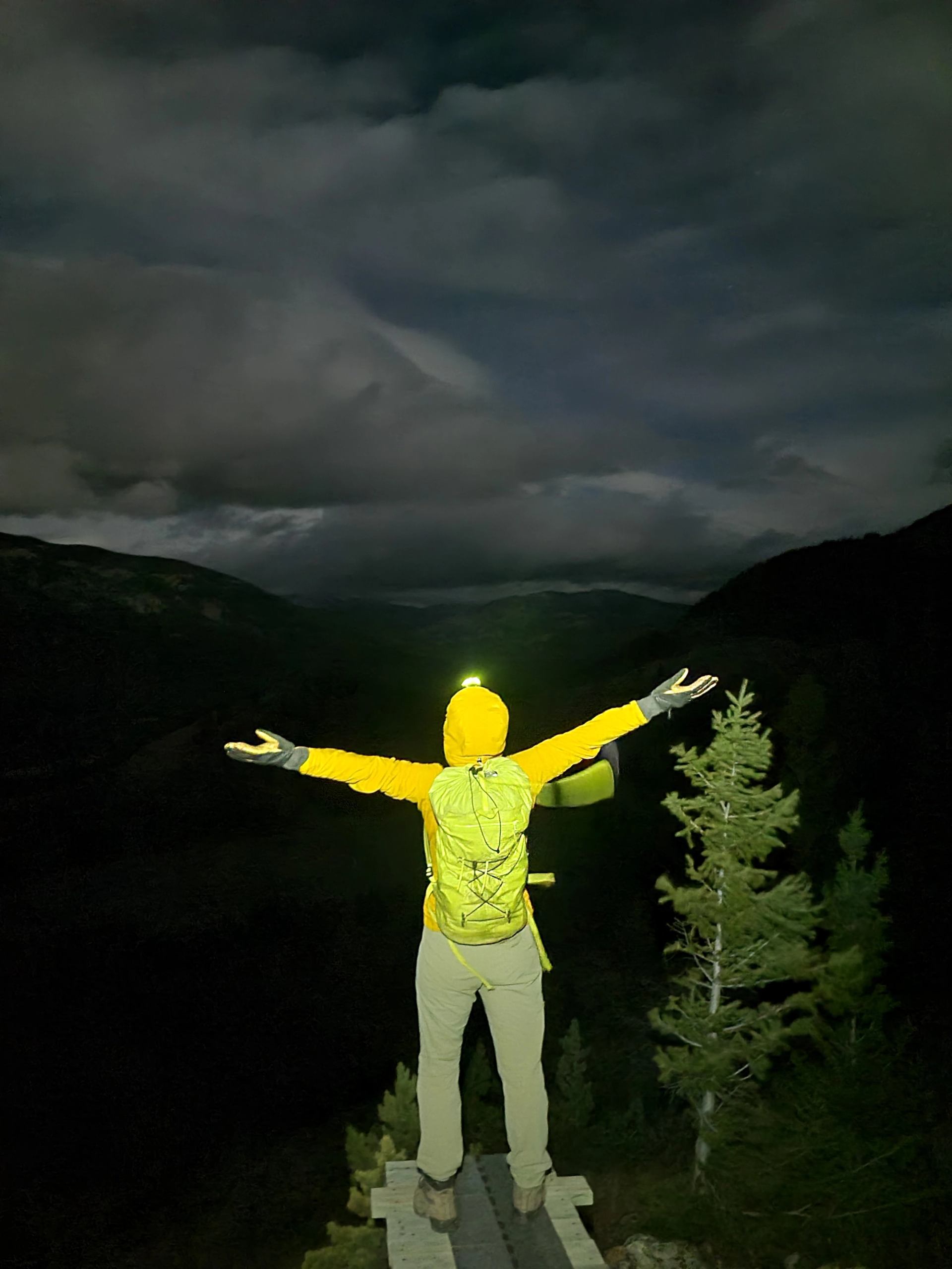 Woman standing in front of the mountains ready to take on the world in Crowsnest Pass