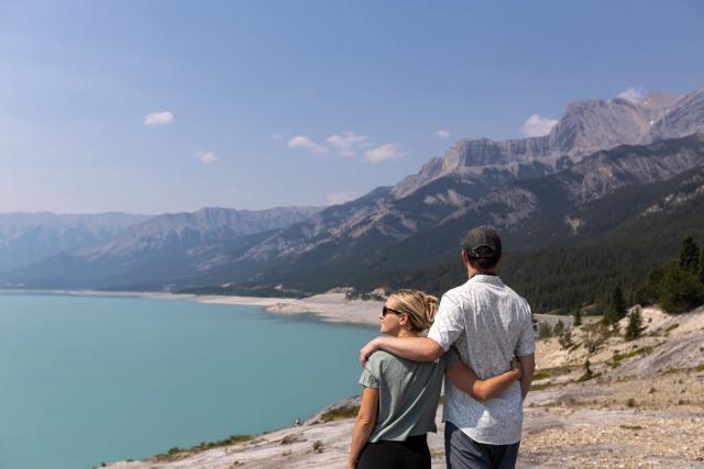 Couple look out at Abraham Lake.