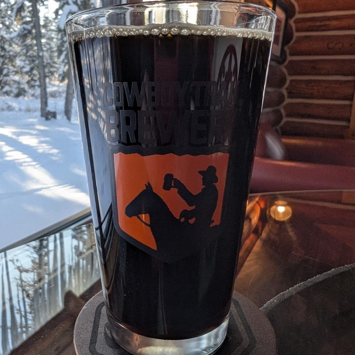 A glass of Cowboy Trail Bourbon Barrel Aged Brown Ale