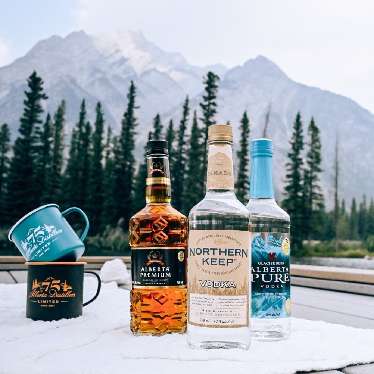 A variety of products Alberta Distillery offer on display with the Three Sisters in the background.