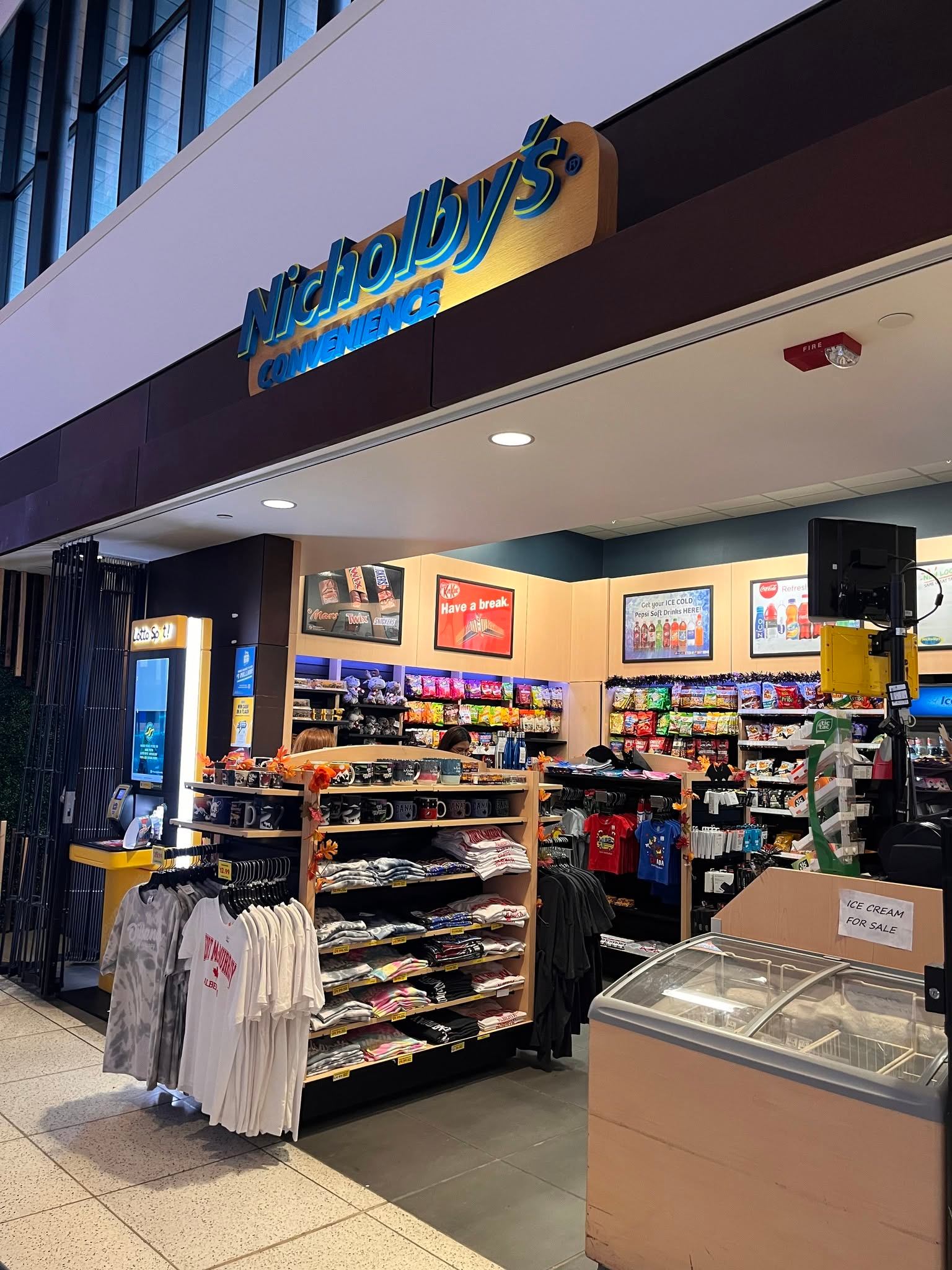Nicholby's Convenience store displays clothing, snacks and an ice cream freezer.