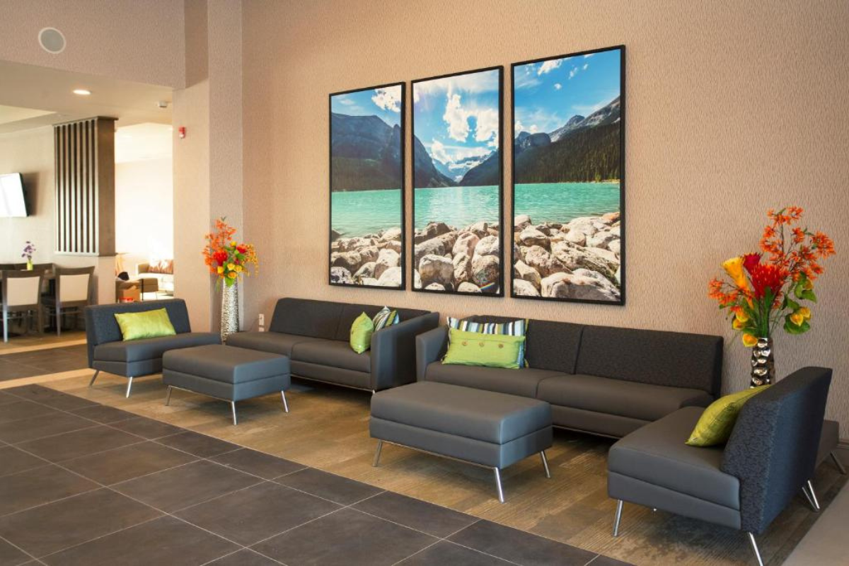 Hotel lobby seating area with sofas, artwork, and decorative floral accents.