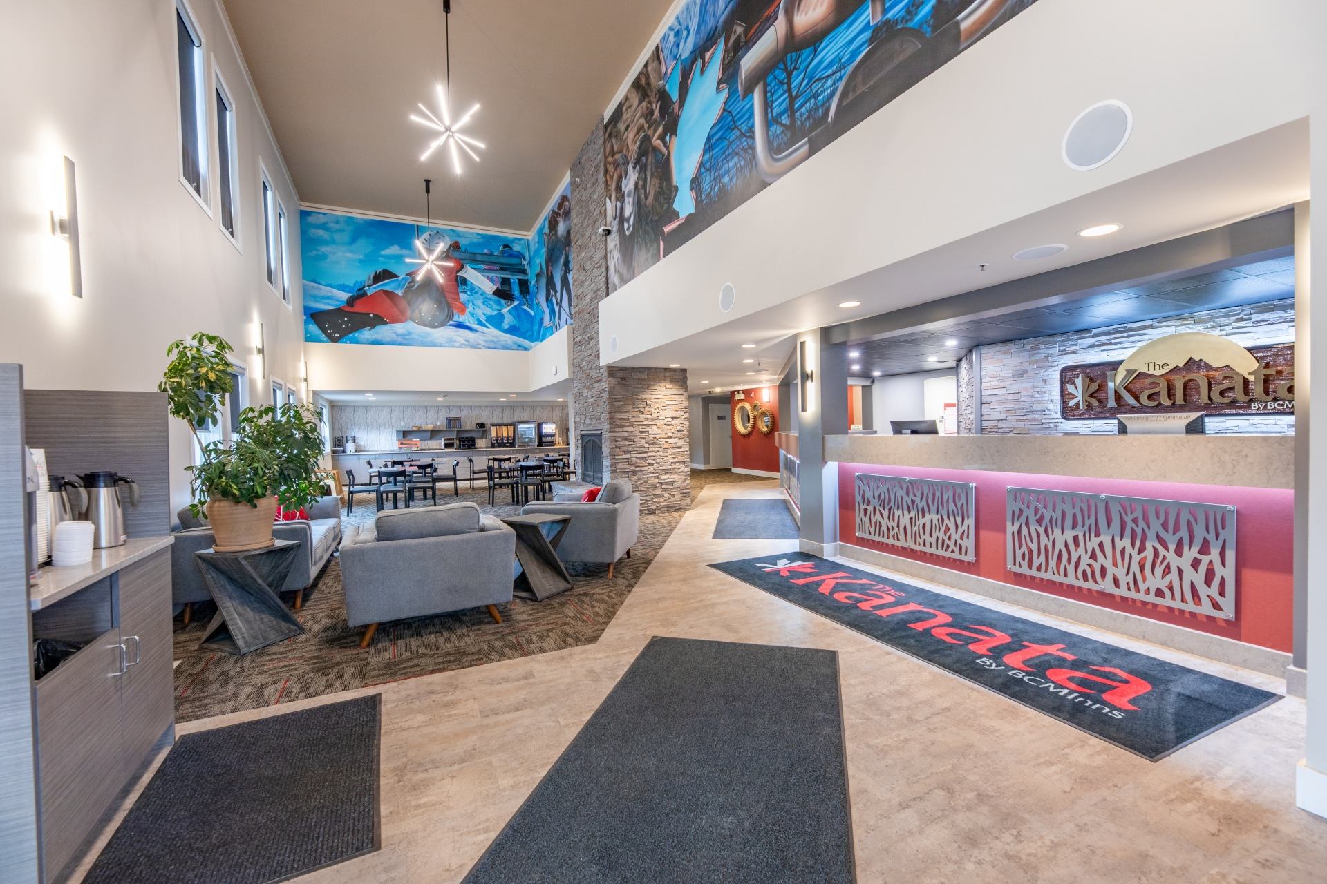 Kanata reception area with lounge seating, stone accents and colourful winter sports murals.