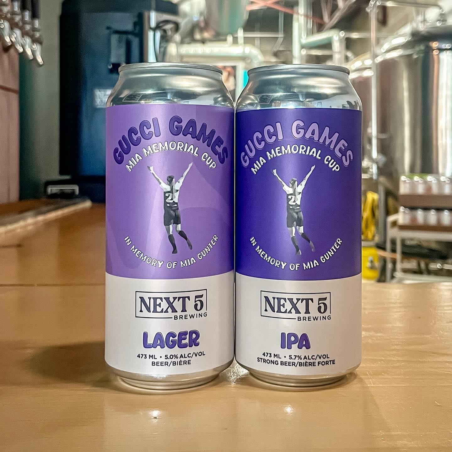 Two Next 5 Brewing cans of lager and IPA displayed inside the brewery.