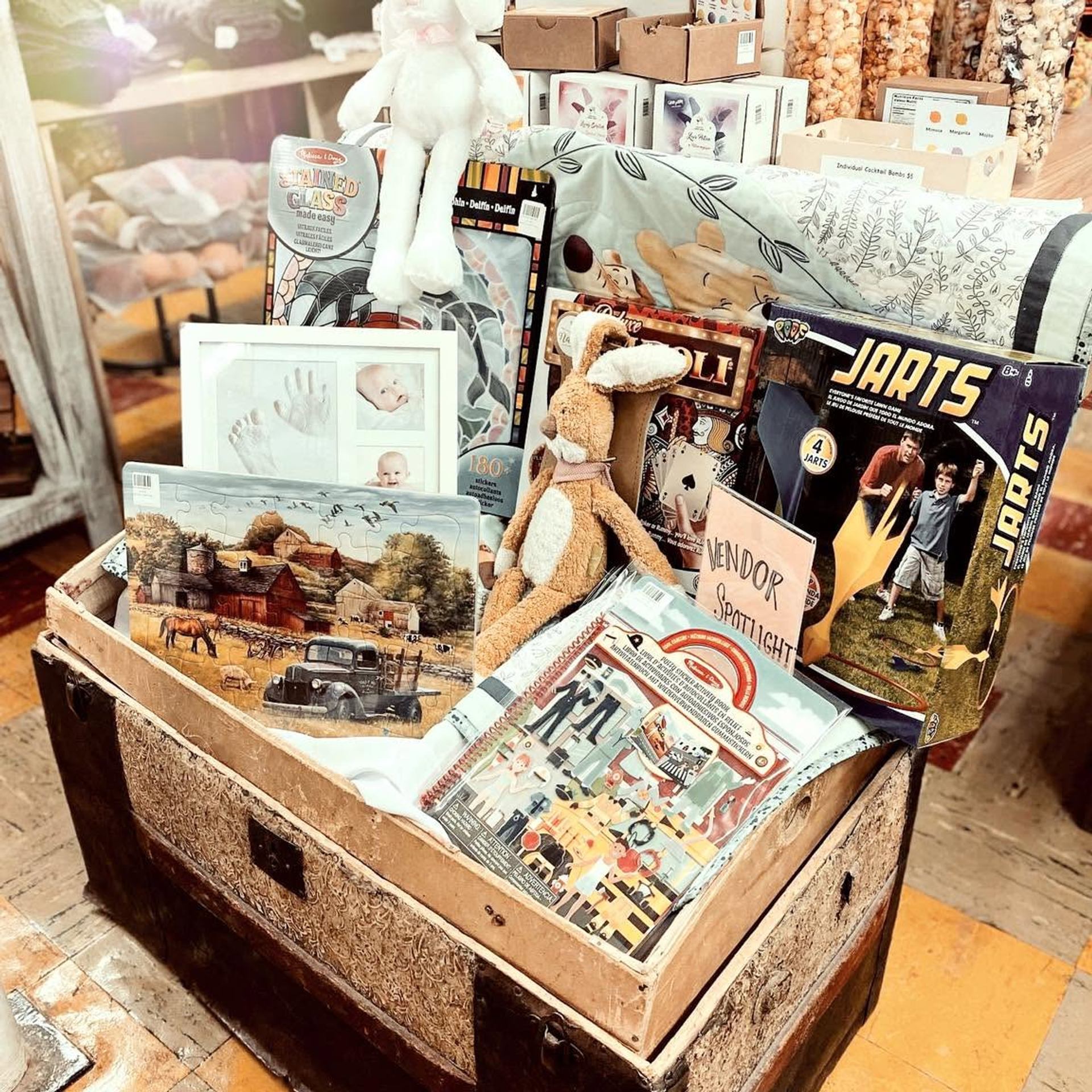 Vintage wooden trunk filled with children’s toys, books, puzzles and framed baby handprints.