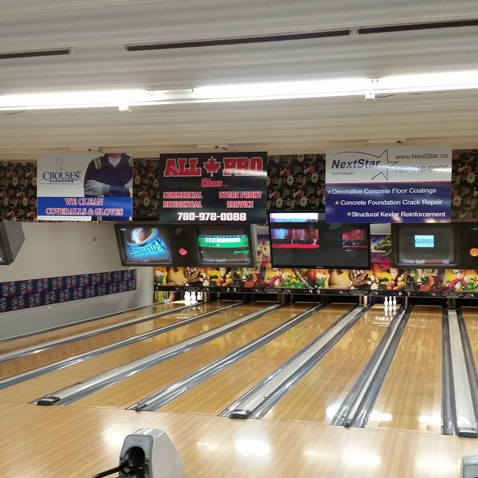 Bowling lanes with pins and score screens inside Bowling Stones Ten Pin Entertainment Centre.
