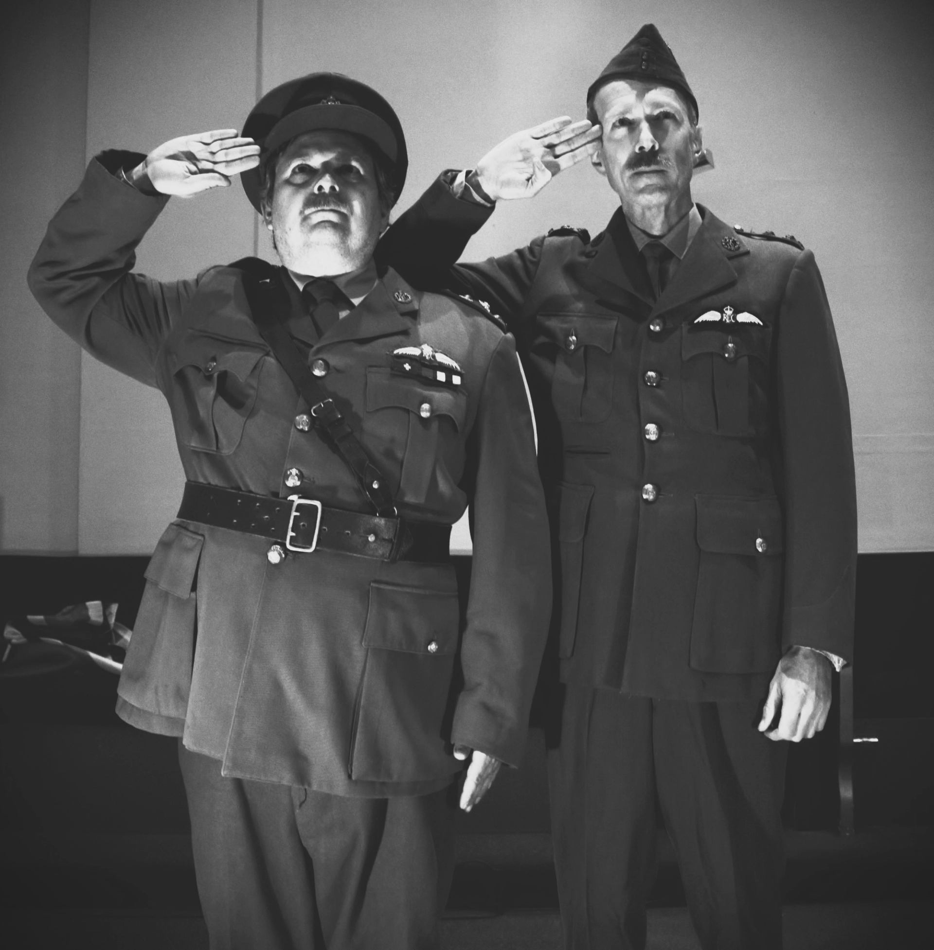 Two soilders saluting.