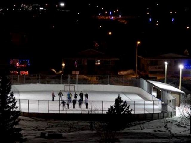 Outdoor ice rink at Multi-Plex Ice Arena with skaters and surrounding lights.