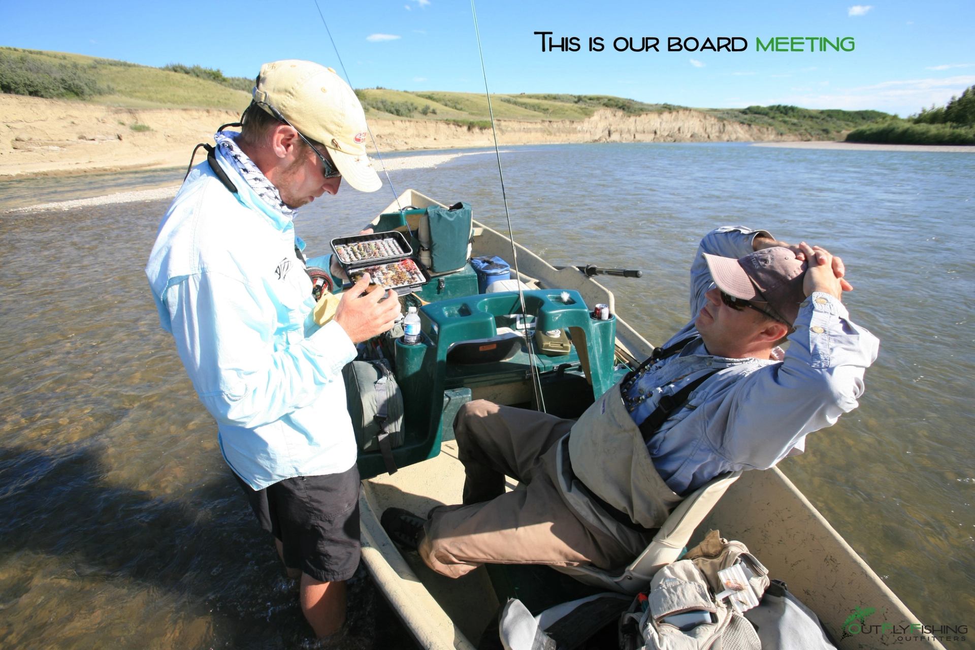 Two men fishing from a drift boat during a sunny day on a calm river.