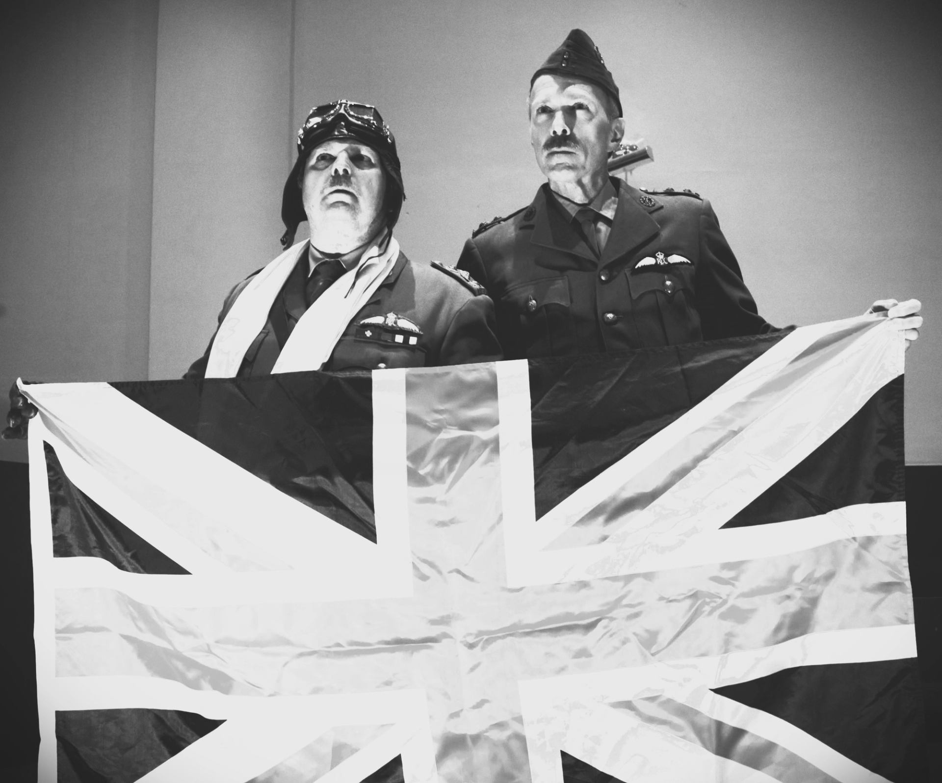 Two soilders holding a flag.