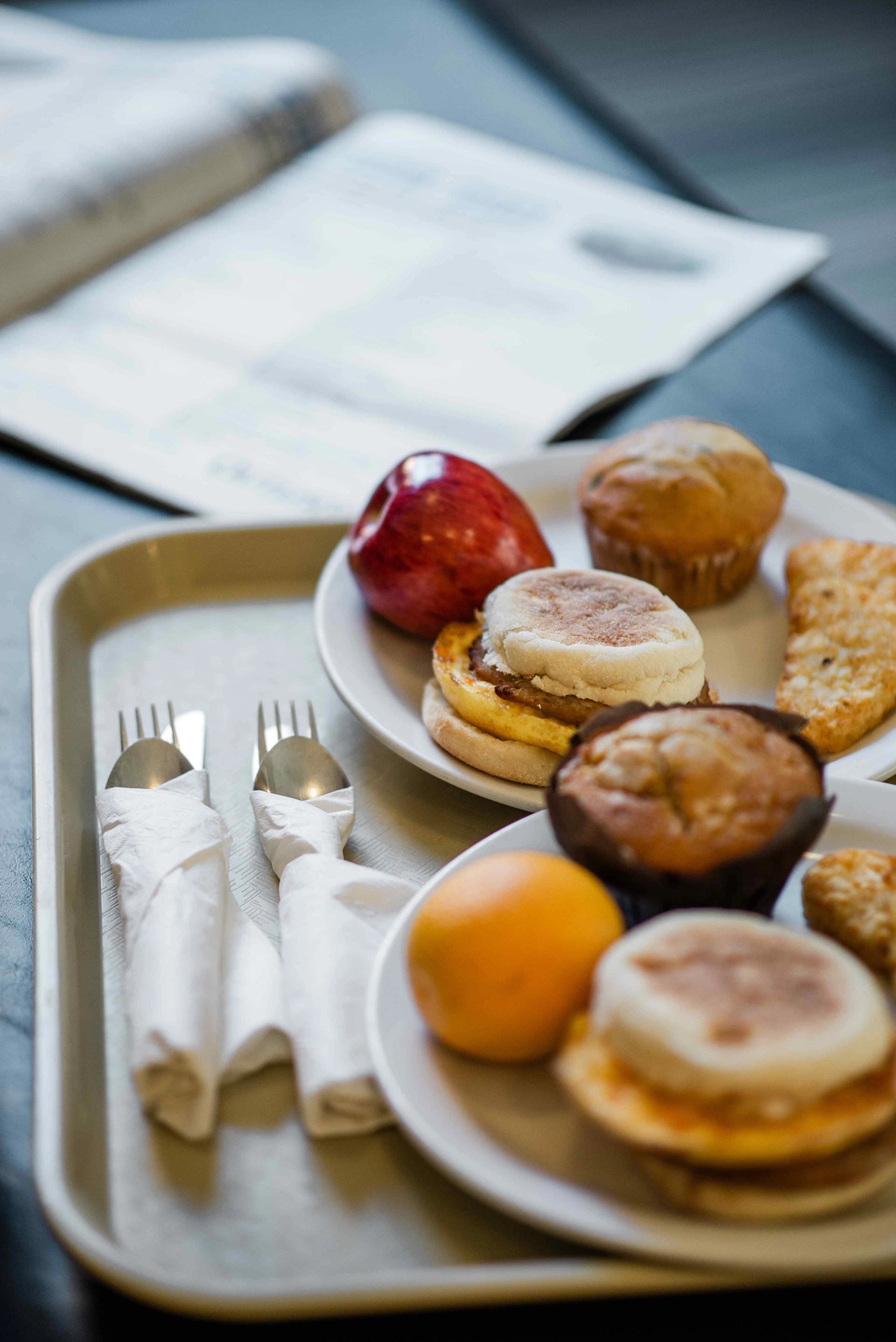 Breakfast tray with muffins, fruit, and sandwiches at Mountaineer Lodge.