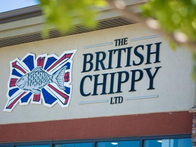 Sign reading The British Chippy Ltd with fish and Union Jack graphic.