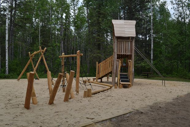 A playground with a swing set, climbing tower, and other fun.