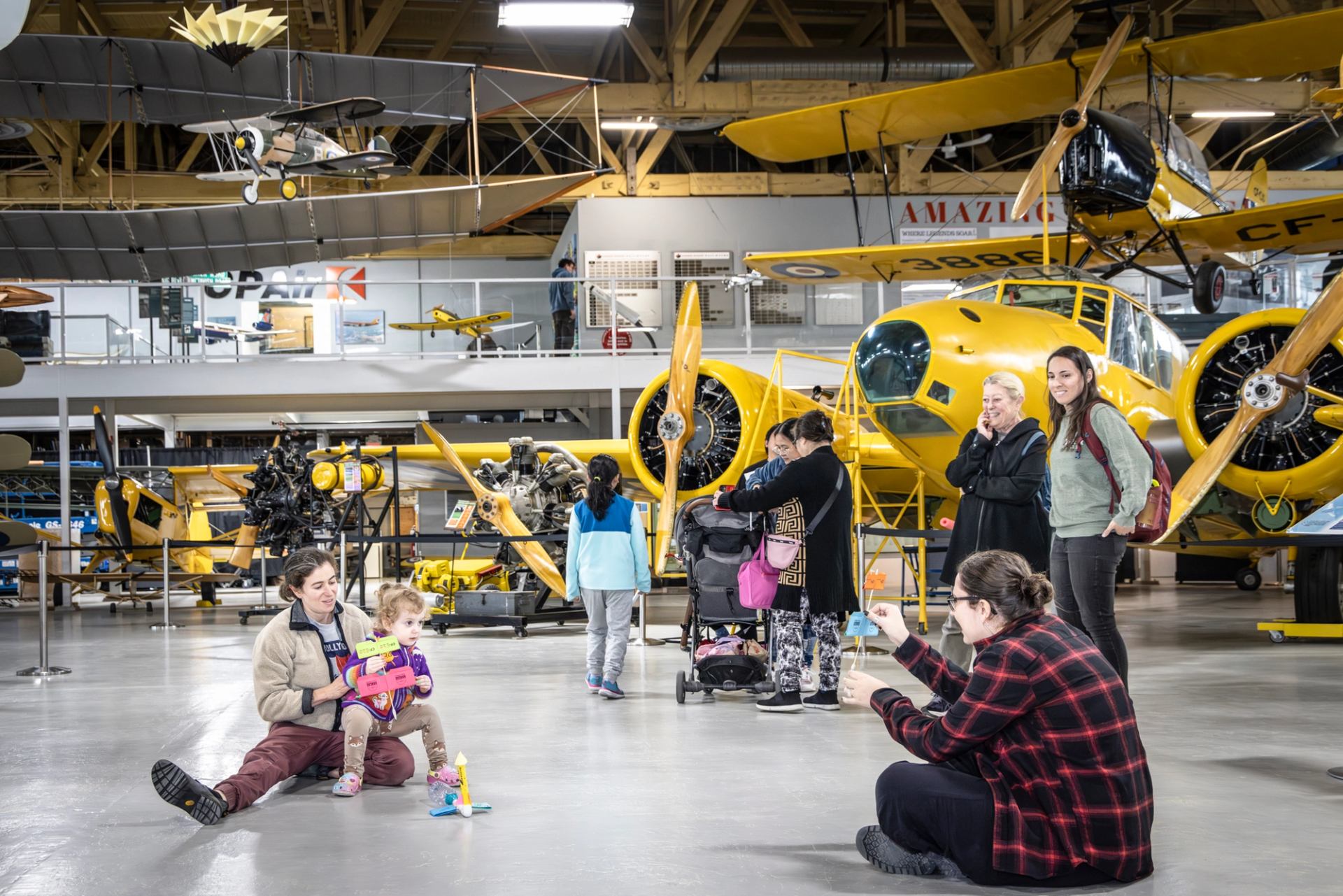 Visitors explore vintage aircraft at The Hangar Flight Museum during a family outing.
