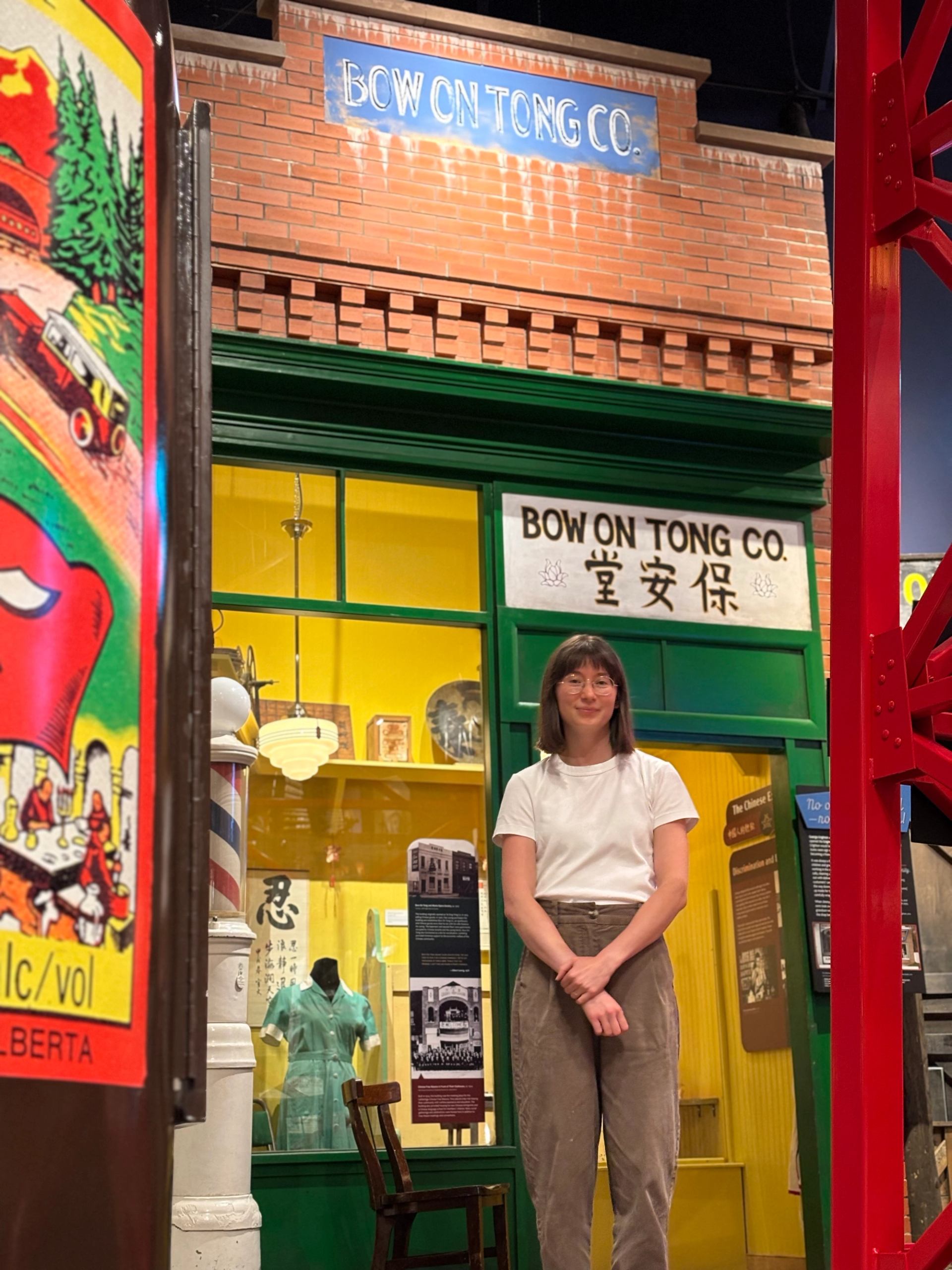 Person stands in front of Bow On Tong Co. storefront inside museum exhibit.