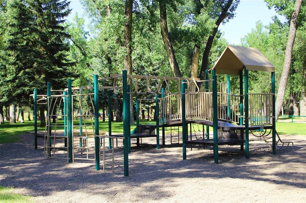 Playground with slides and climbing bars at Taber Municipal Park.
