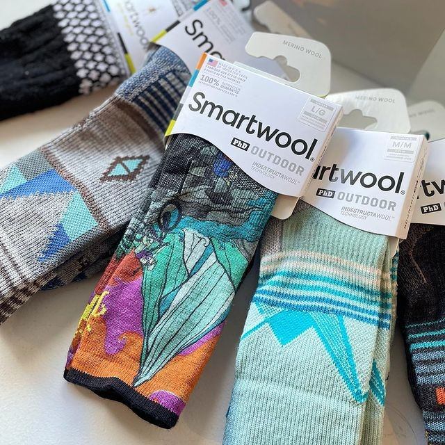 Display of colorful Smartwool Outdoor socks with branded packaging.