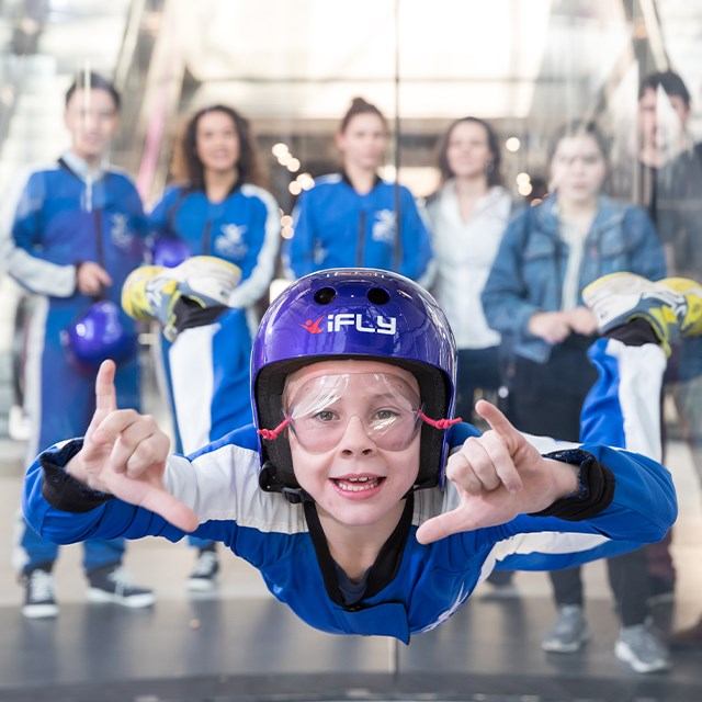A young person skydiving inside the tunnel