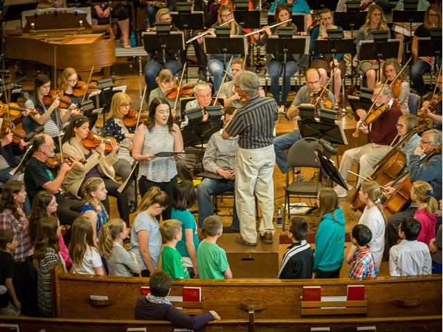 A group of young children watching the Orchestra