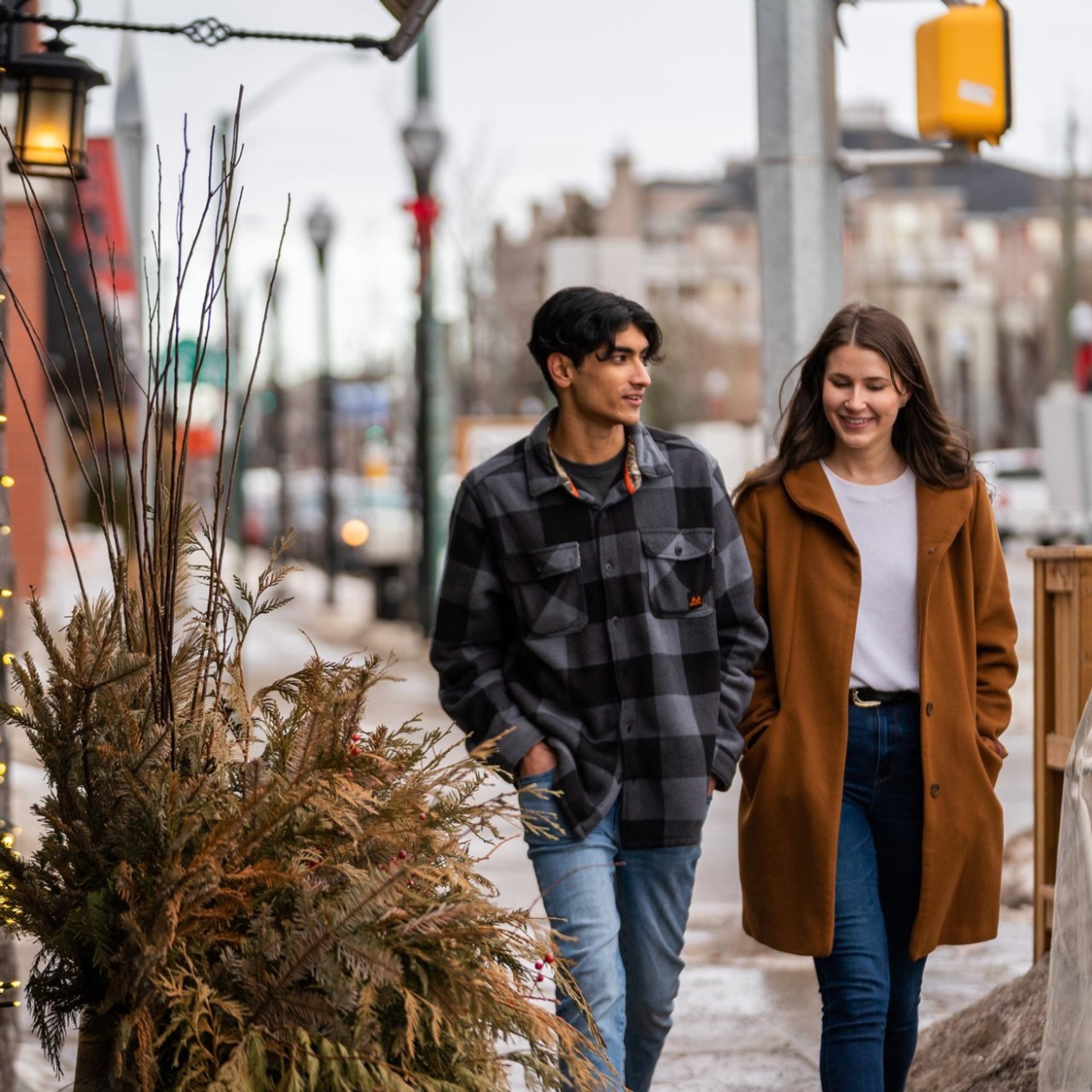 Two people walking and chatting on a city sidewalk during the 124th Food Walk Tour.