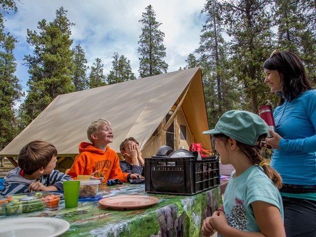 Family enjoying a meal at a picnic table at Whistlers Camprground.