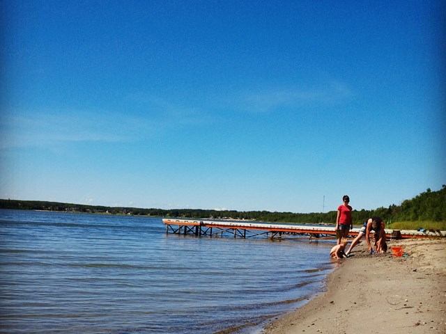 Two people walking along the beach