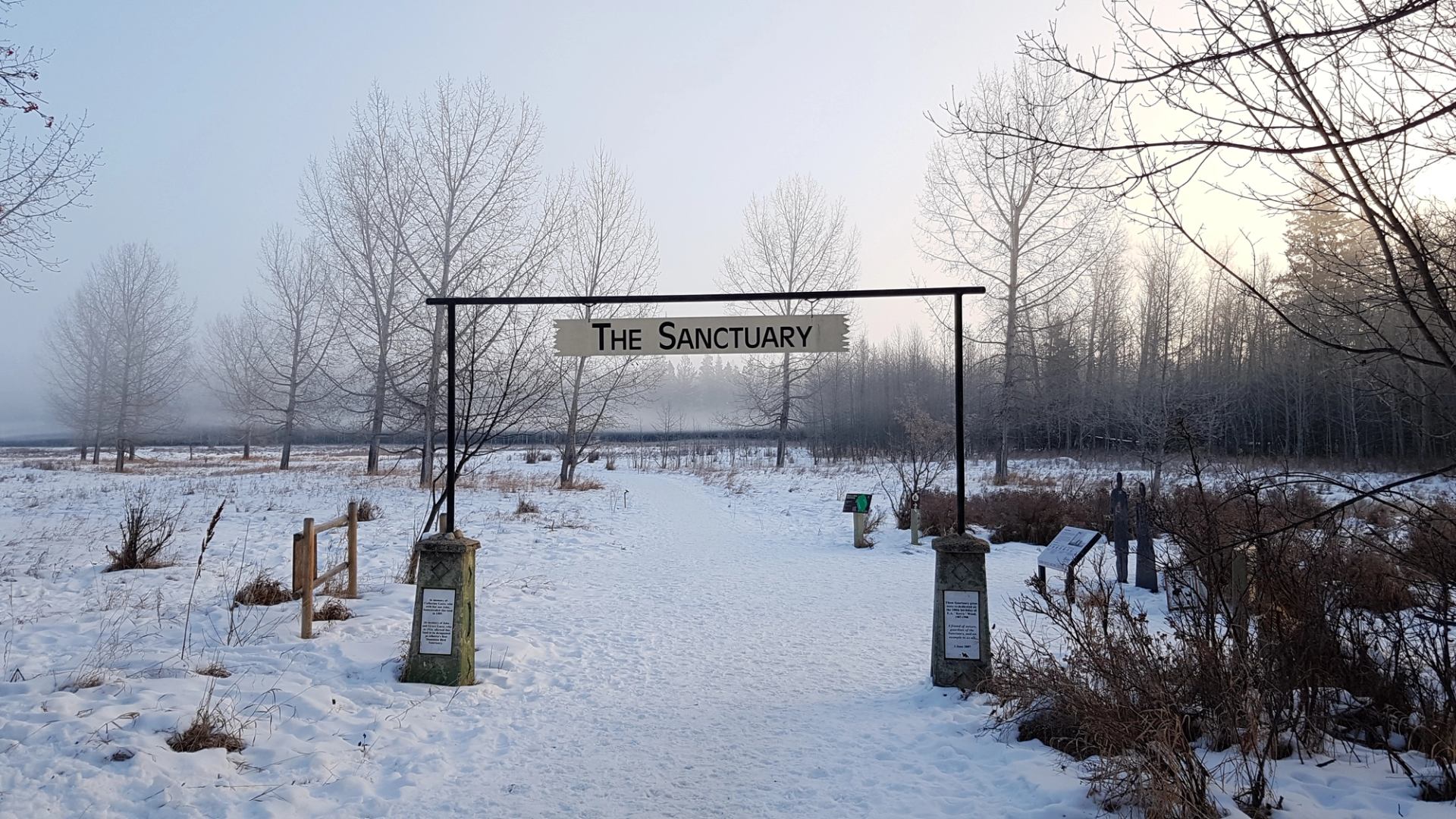 Snow-covered entrance to Gaetz Lakes Sanctuary with sign reading “The Sanctuary.”