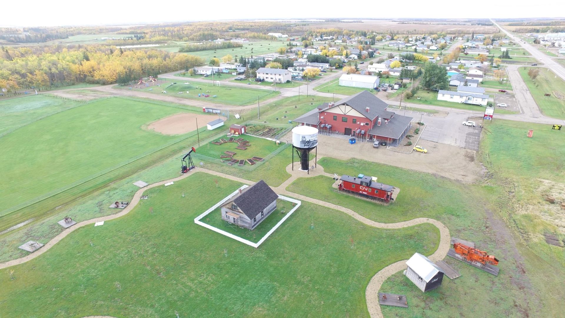 Aerial view of Nampa and District Museum with historic buildings and green fields.