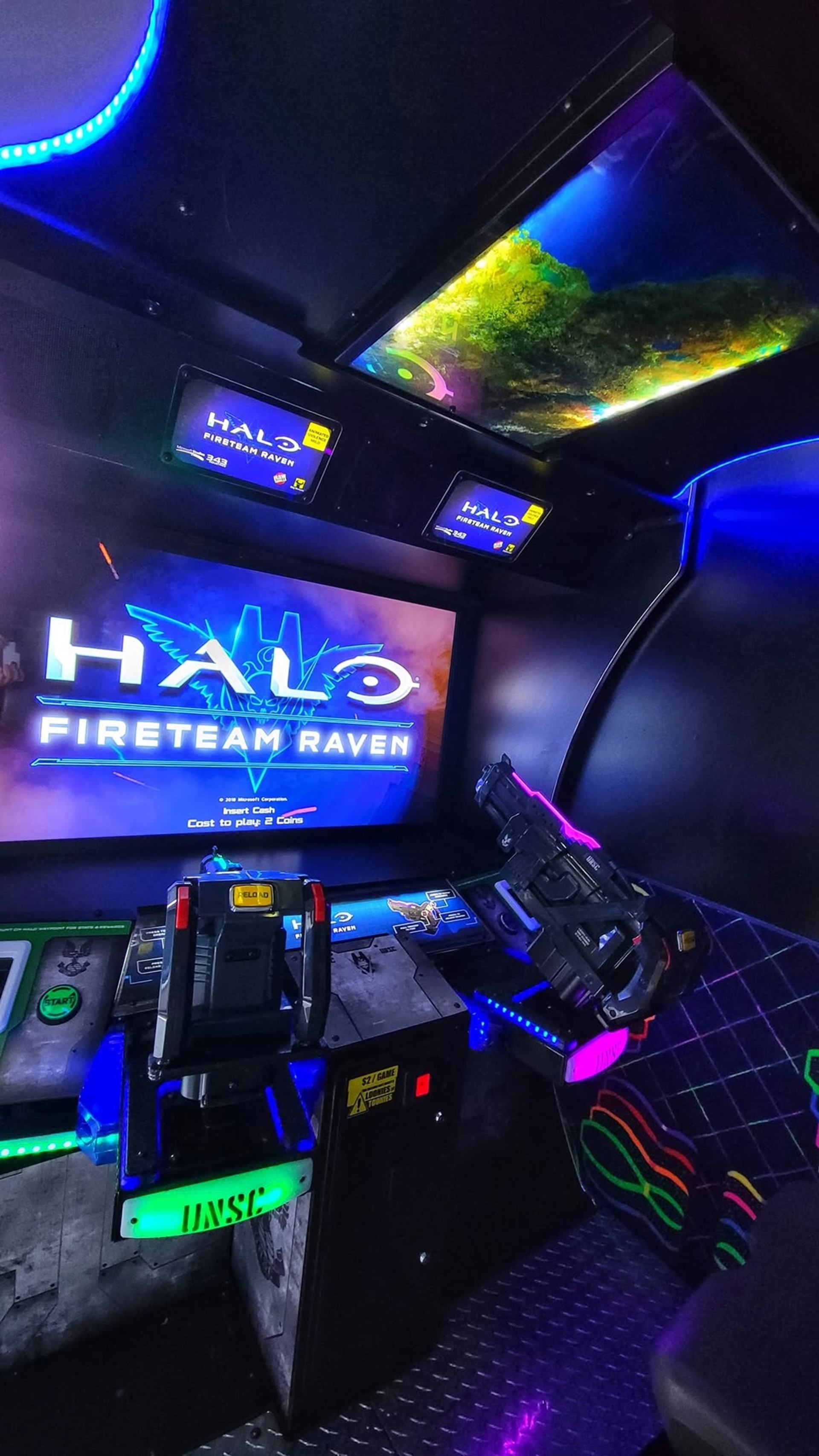 Halo Fireteam Raven arcade cabinet with mounted light gun and glowing control panels.