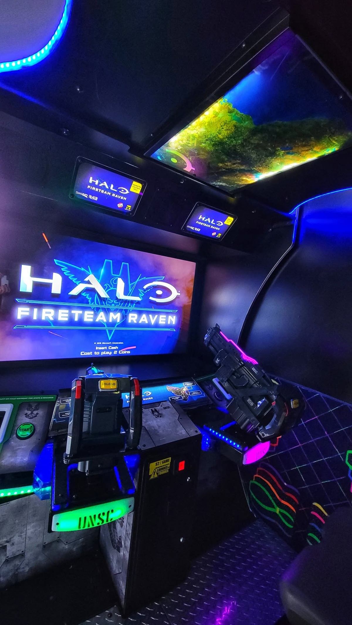 Halo Fireteam Raven arcade cabinet with mounted light gun and glowing control panels.