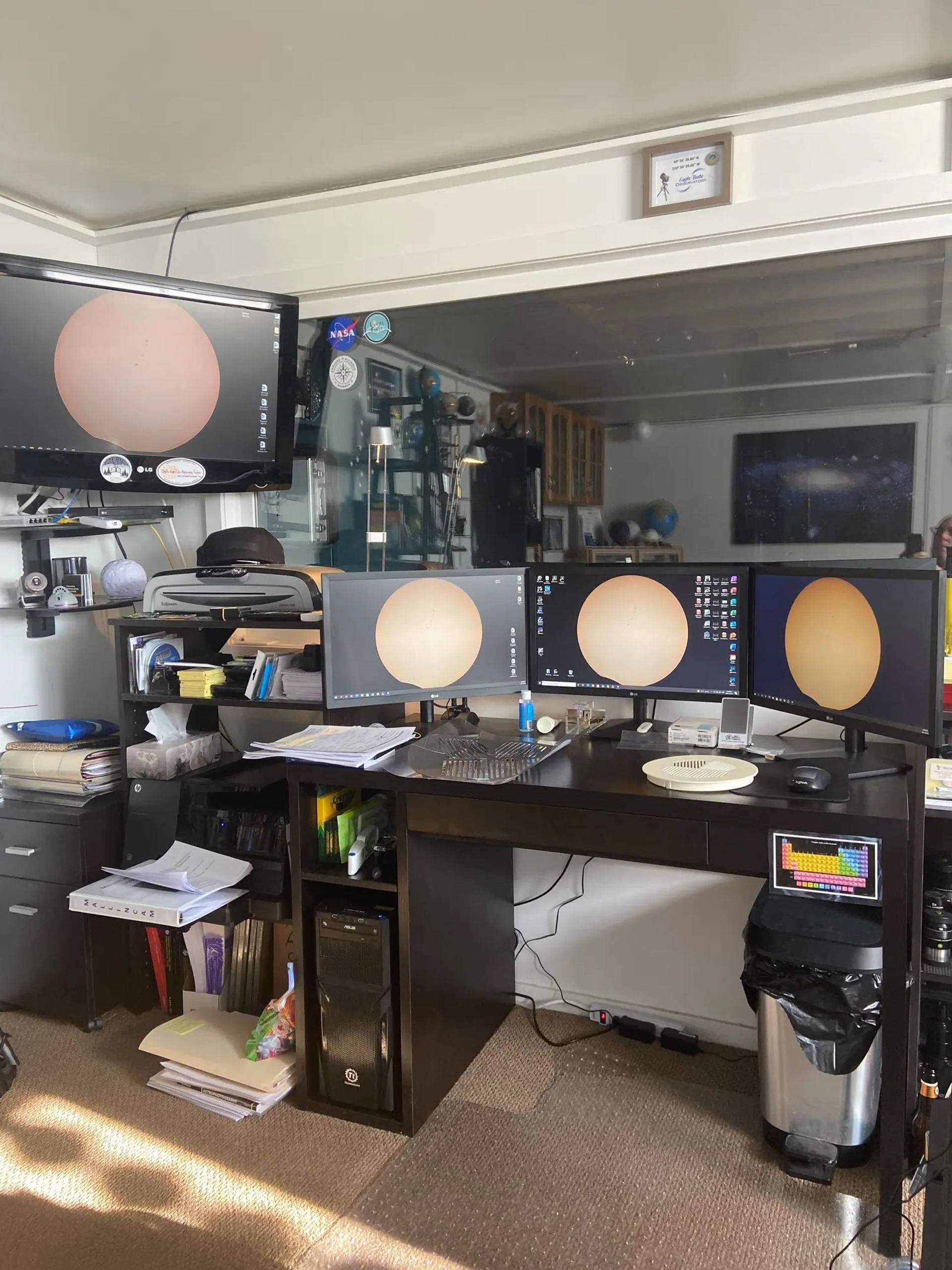 Multi-monitor workstation showing spherical object on screens.