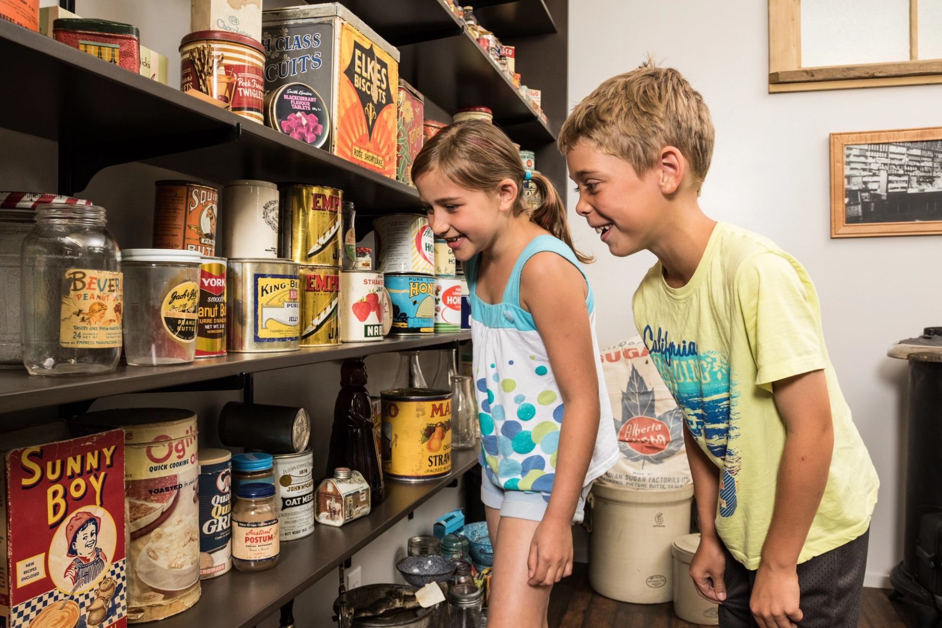 Shelves filled with old-fashioned cans and jars in a museum display