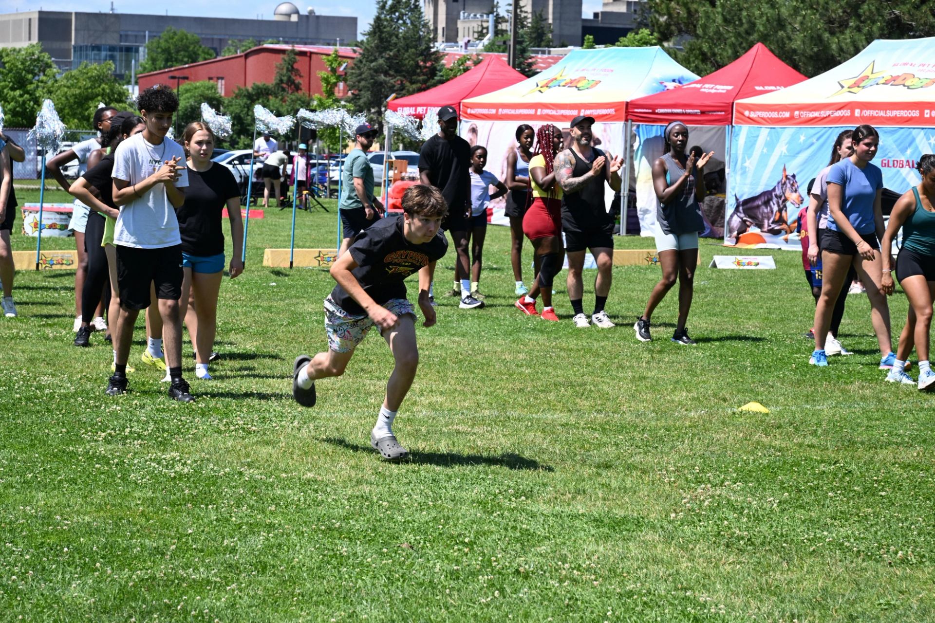 Participant runs on grassy field during outdoor event at The Good Games.