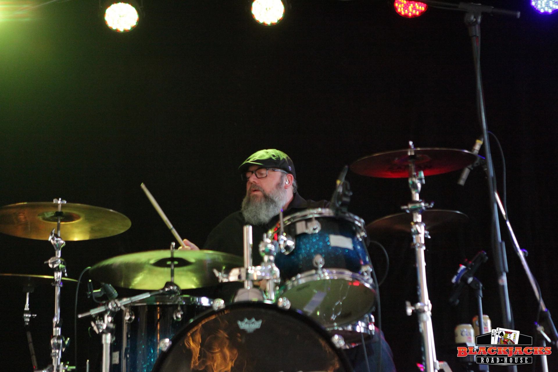 A band member playing the mdrus on stage.