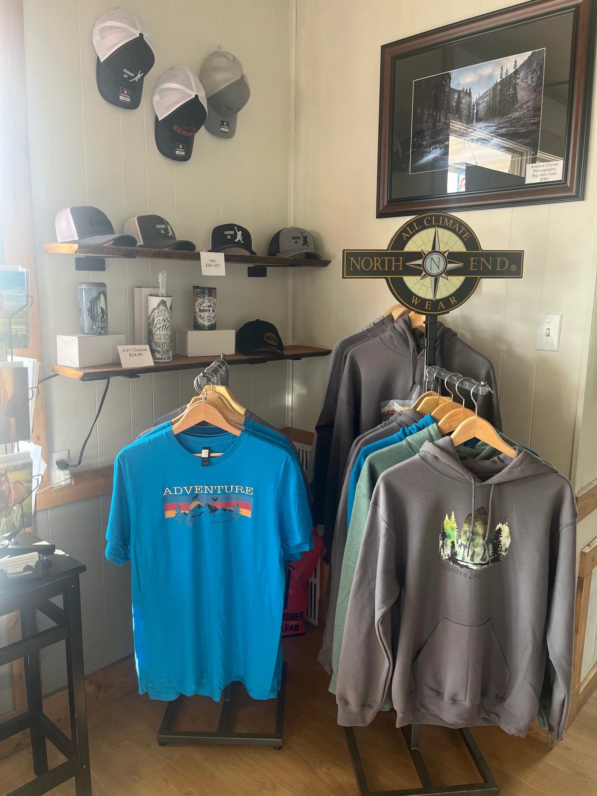Hats, hoodies, and Sundre t-shirt on display at Sundre Visitor Information Centre.