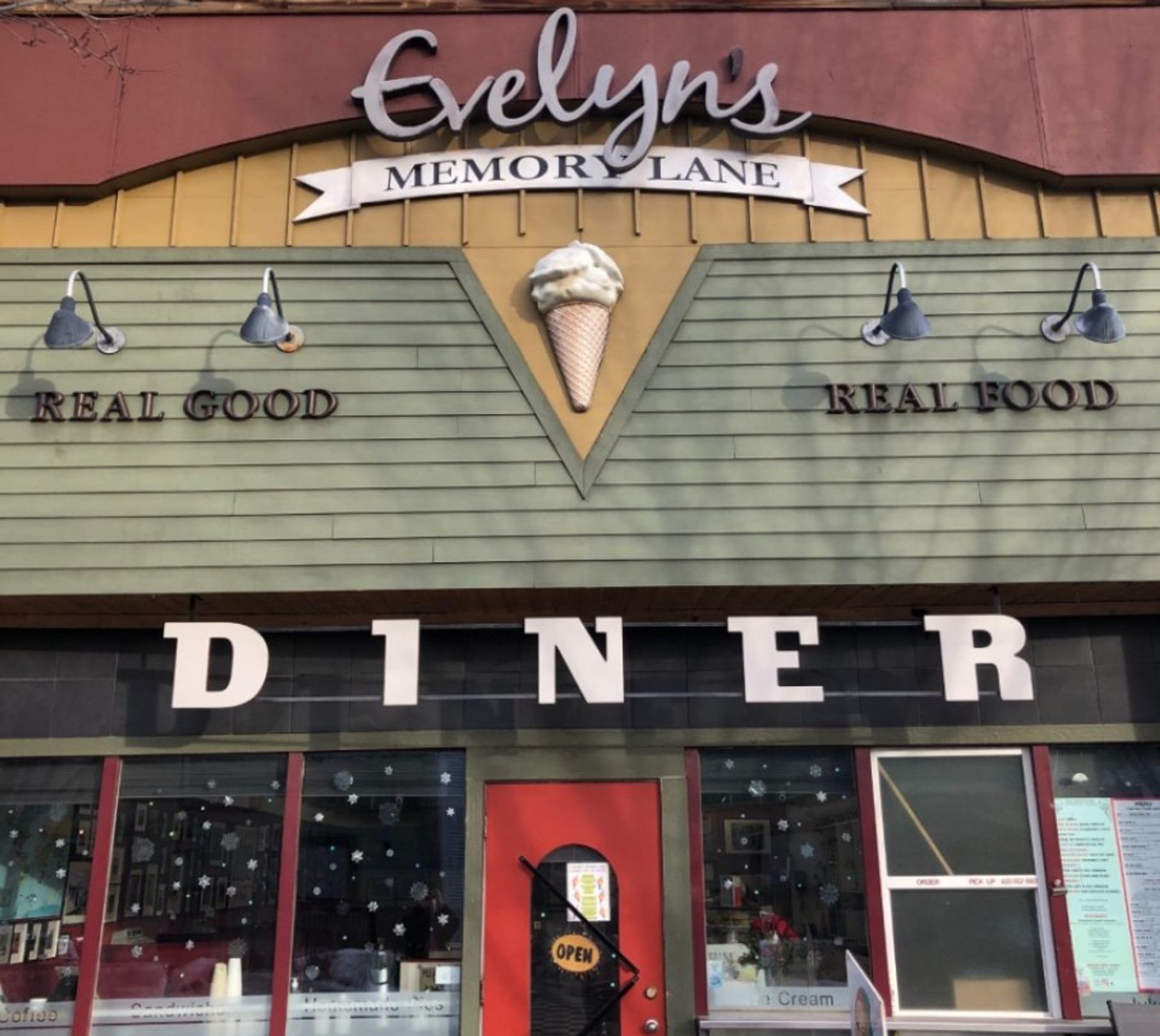 Exterior of Evelyn’s Memory Lane diner with large Diner lettering and open entrance.