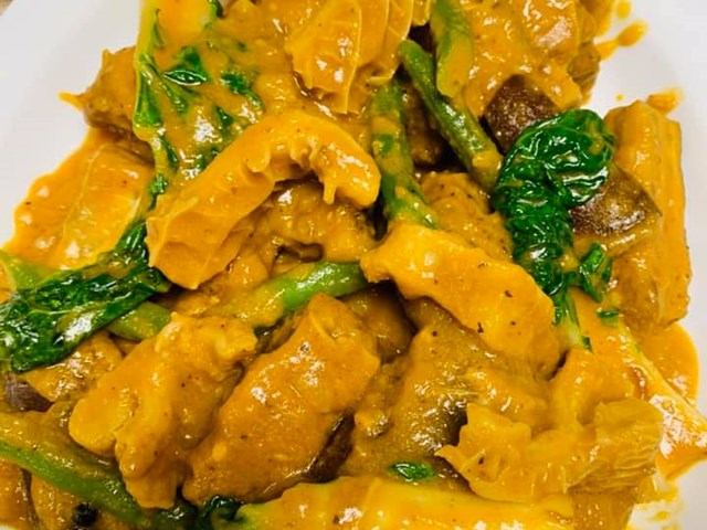 Chicken gizzards in a rich orange sauce with green beans and fresh herbs.