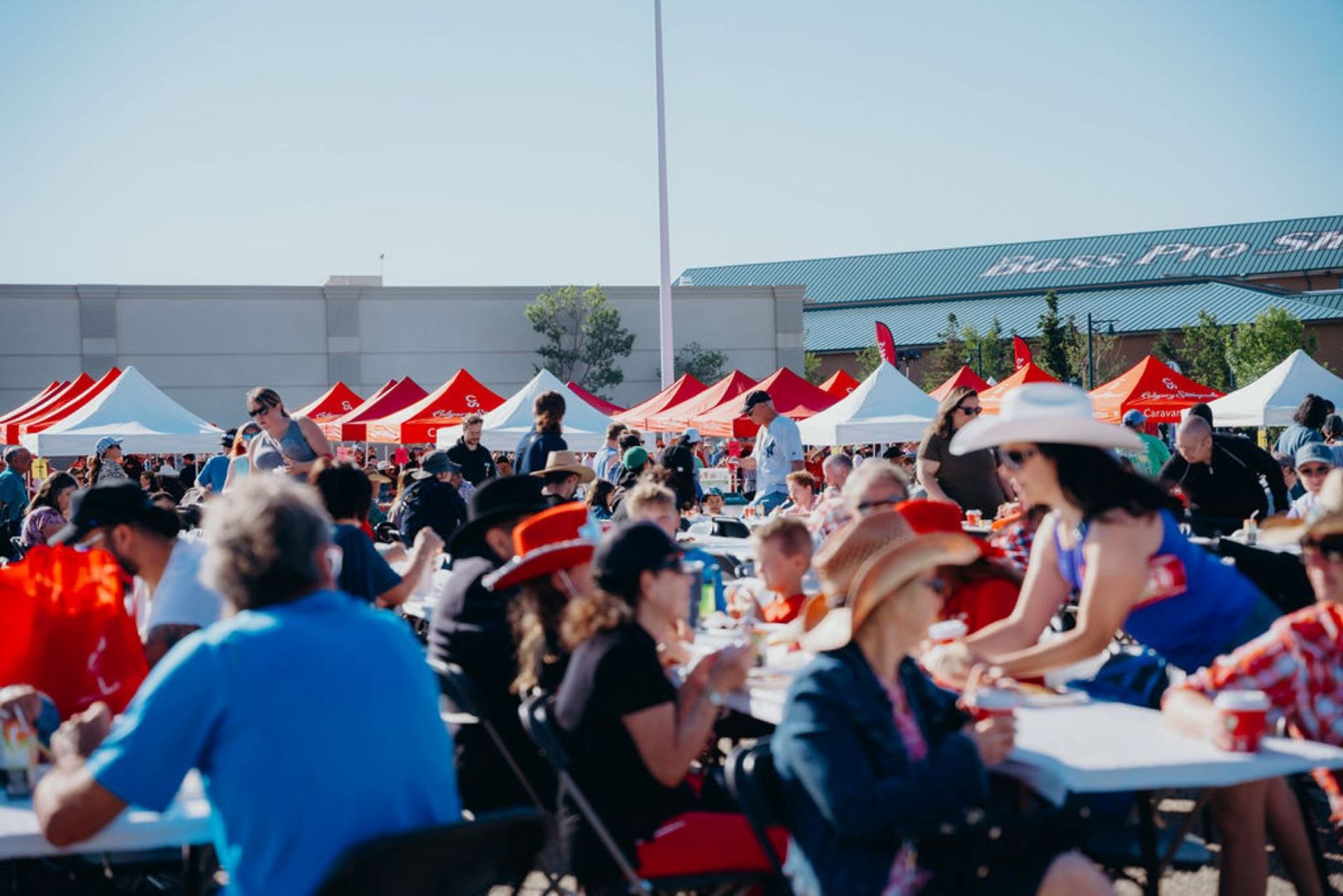People sat enjoying CrossIron Mills Stampede Breakfast.