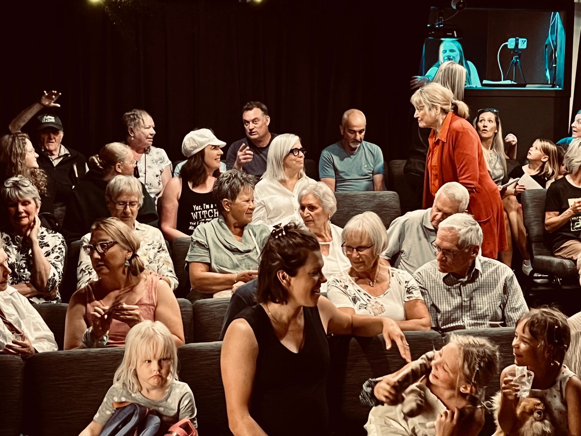 Theatergoers chat before Into The Woods performance in cozy venue.