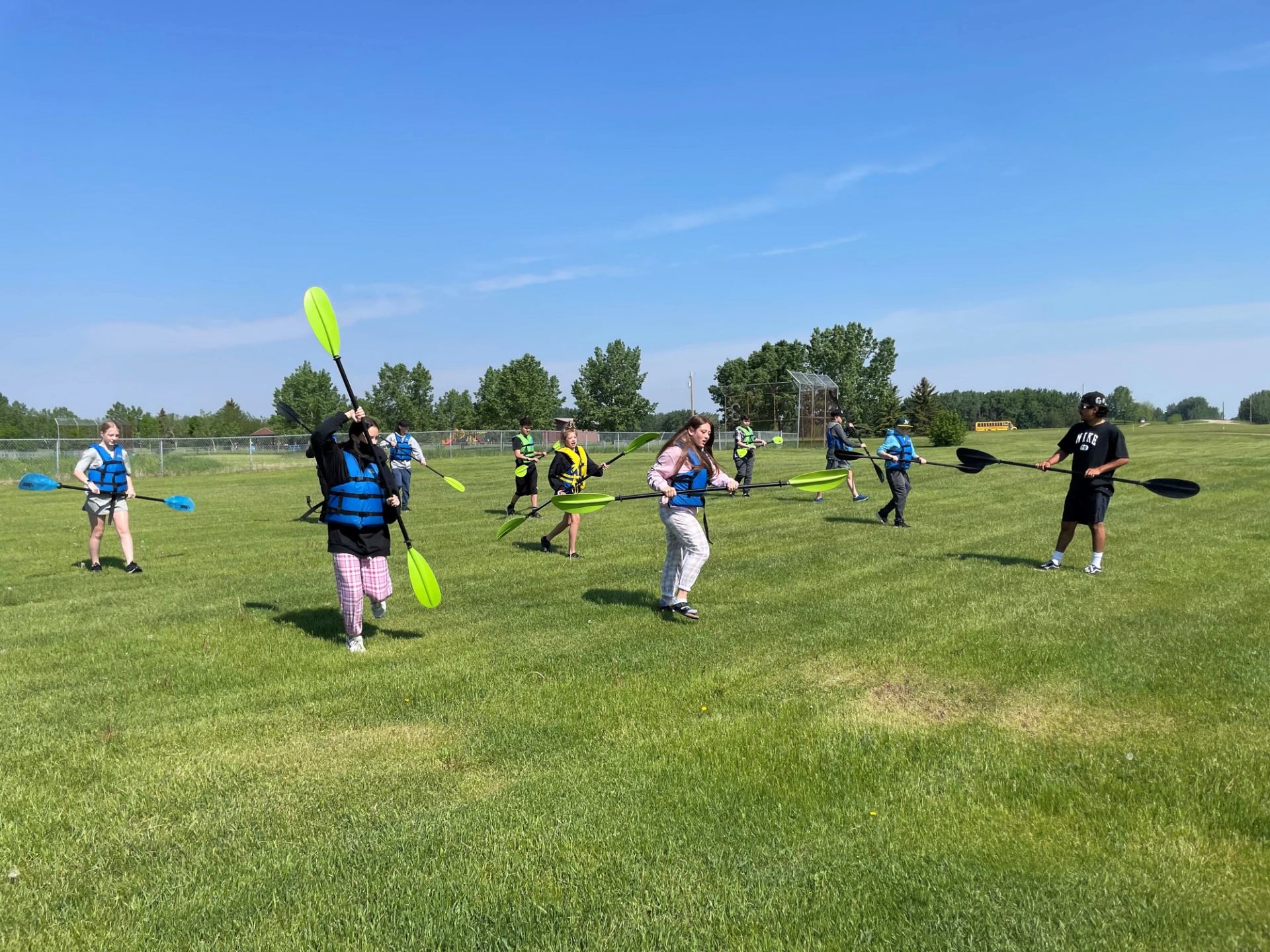 A group of people holding paddles