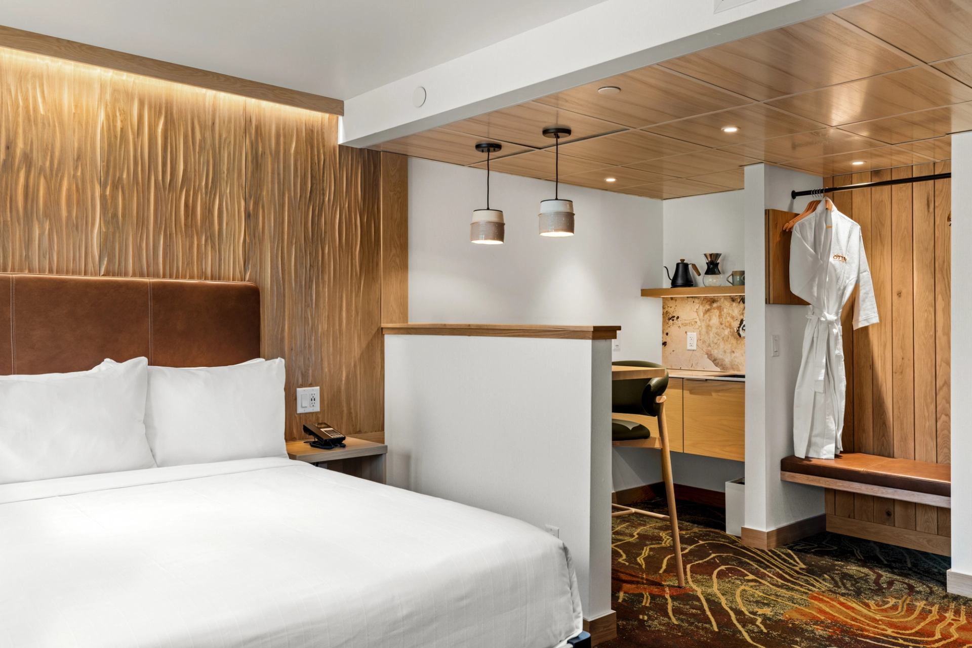 View of king suite kitchenette and in-room bar dining area at the Otter Hotel