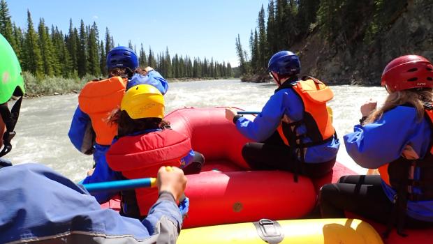 A group of people on a raft tour on the river.