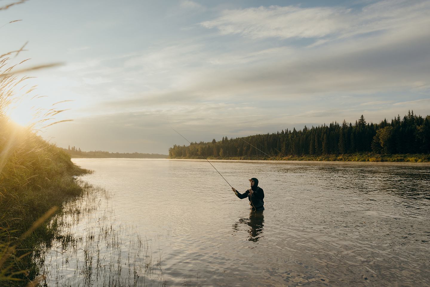 A man in the lake fishing