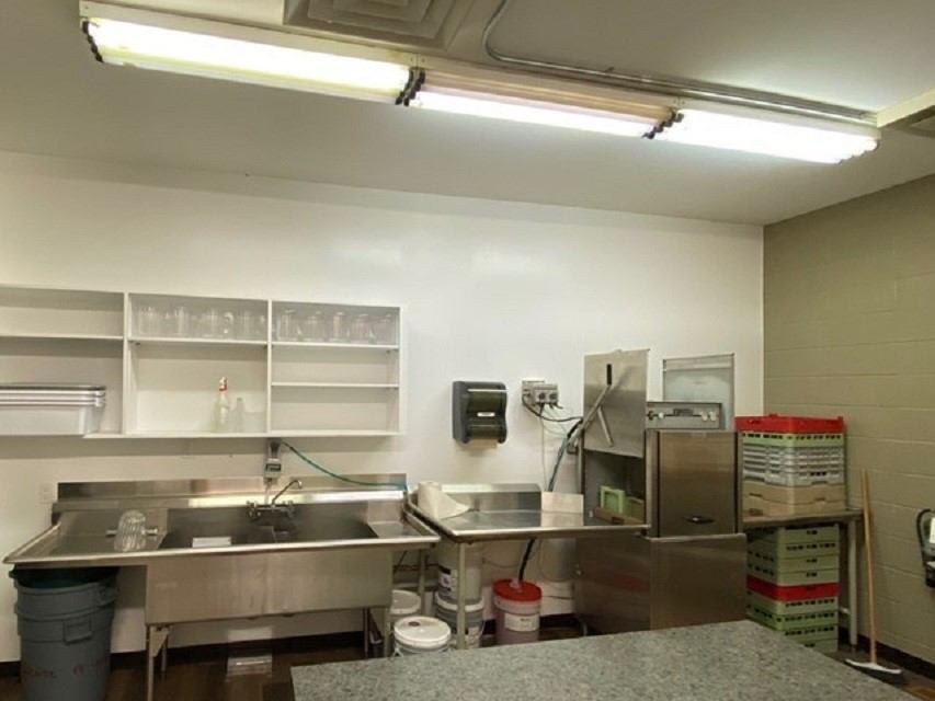 Industrial kitchen counter and equipment inside Beaverlodge Recreation Centre recreation facility.