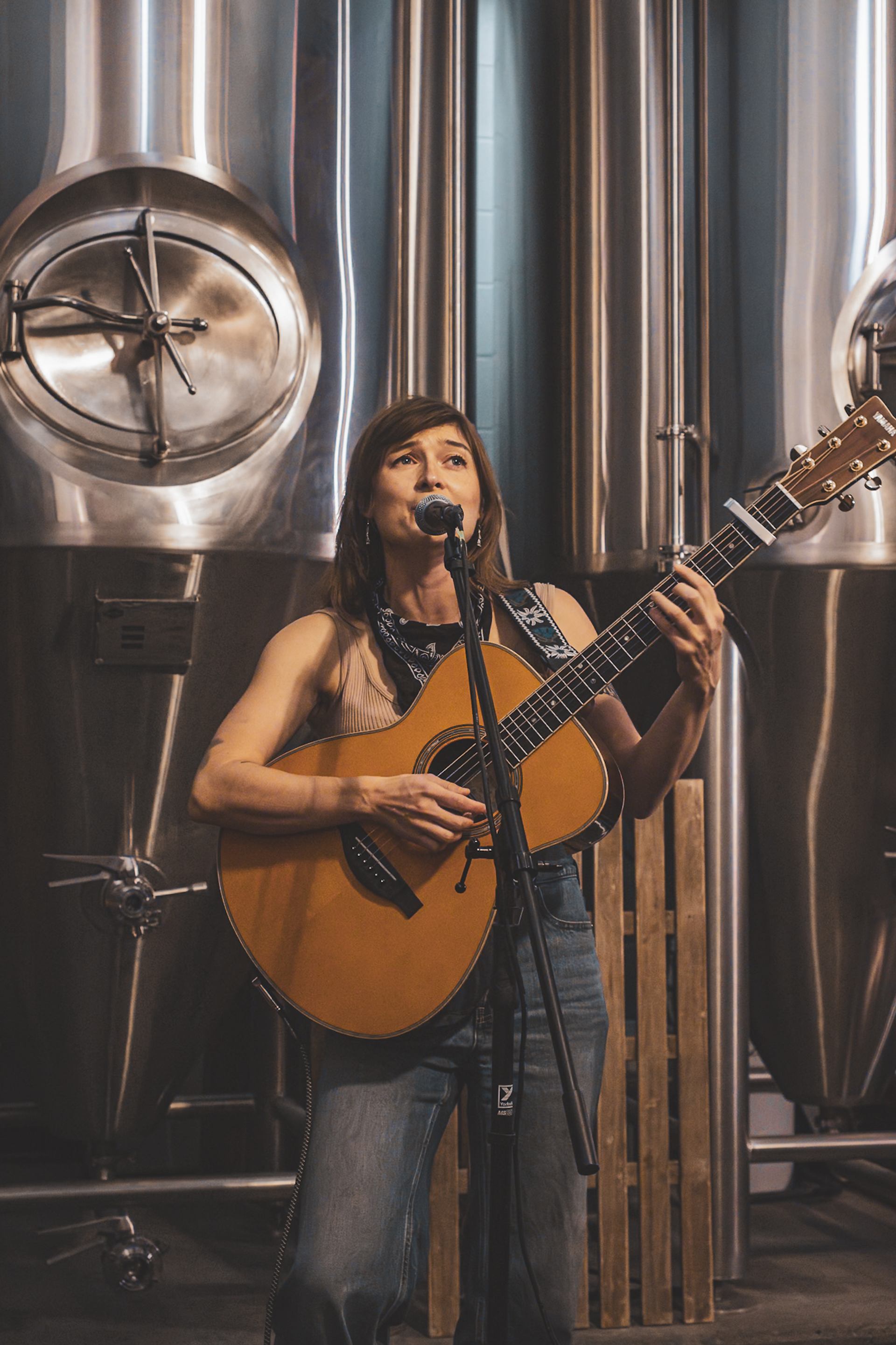Local musician playing guitar at Wild Life Distillery Open Mic Nights