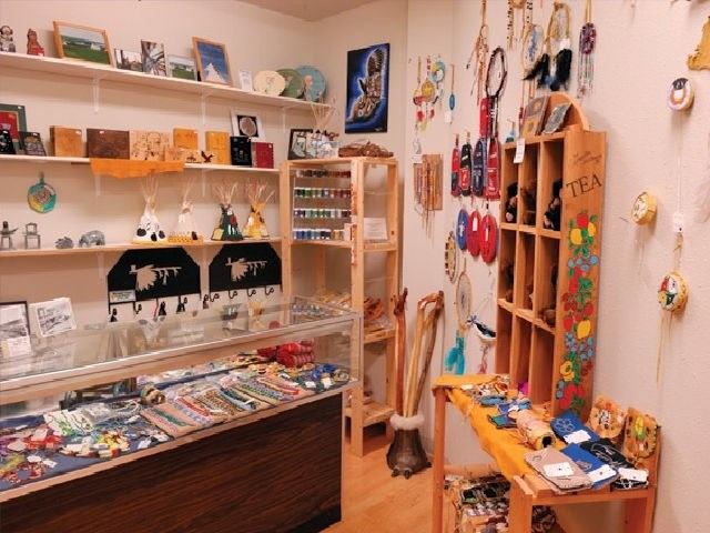 Shop interior with handcrafted jewelry, dreamcatchers, and cultural art pieces.