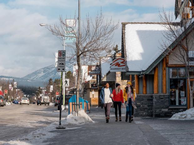 Friends walking down Patricia St. in downtown Jasper in Jasper National Park.