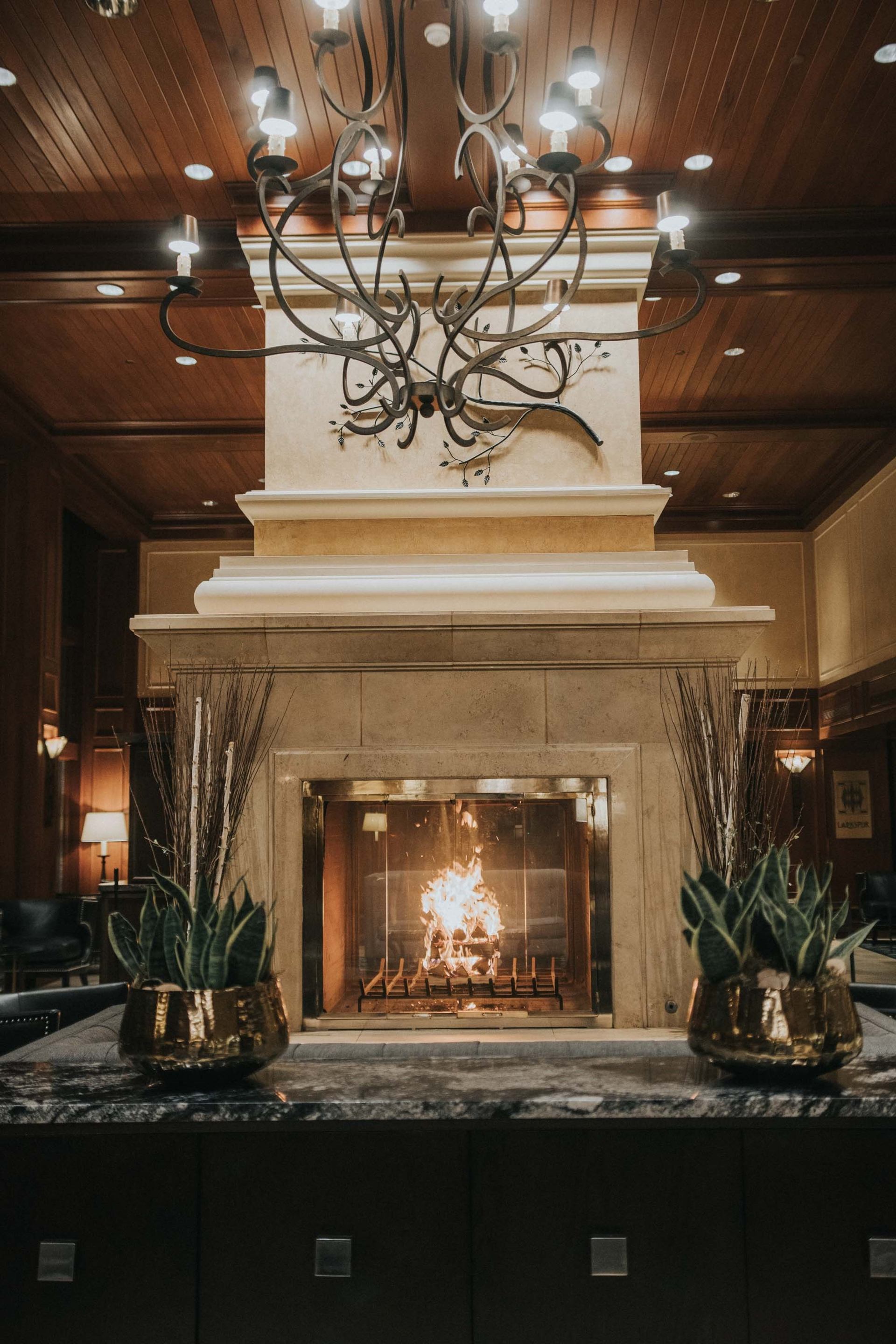 Roaring fire in the Grand Fireplace in Larkspur at Rimrock Banff