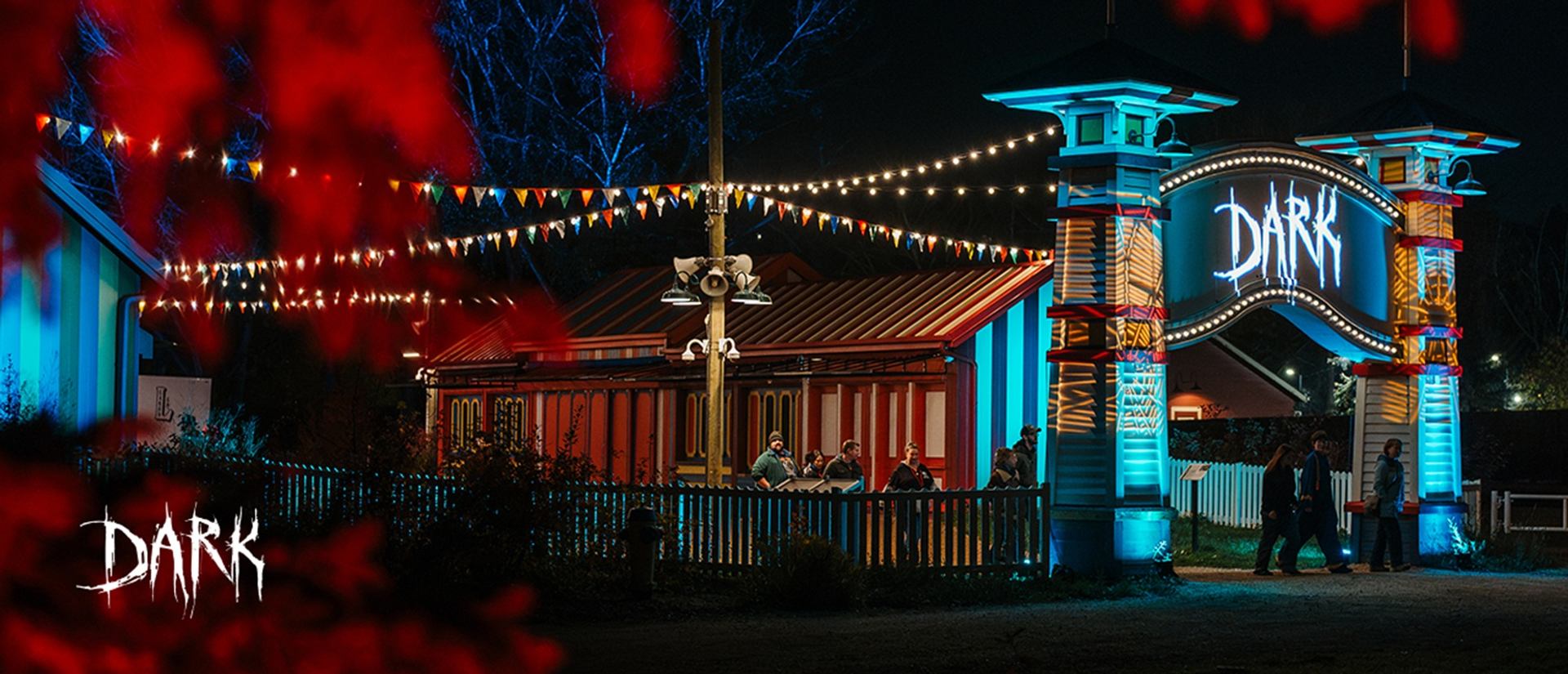The glowing entrance to DARK Halloween festival lit with eerie blue and red lights